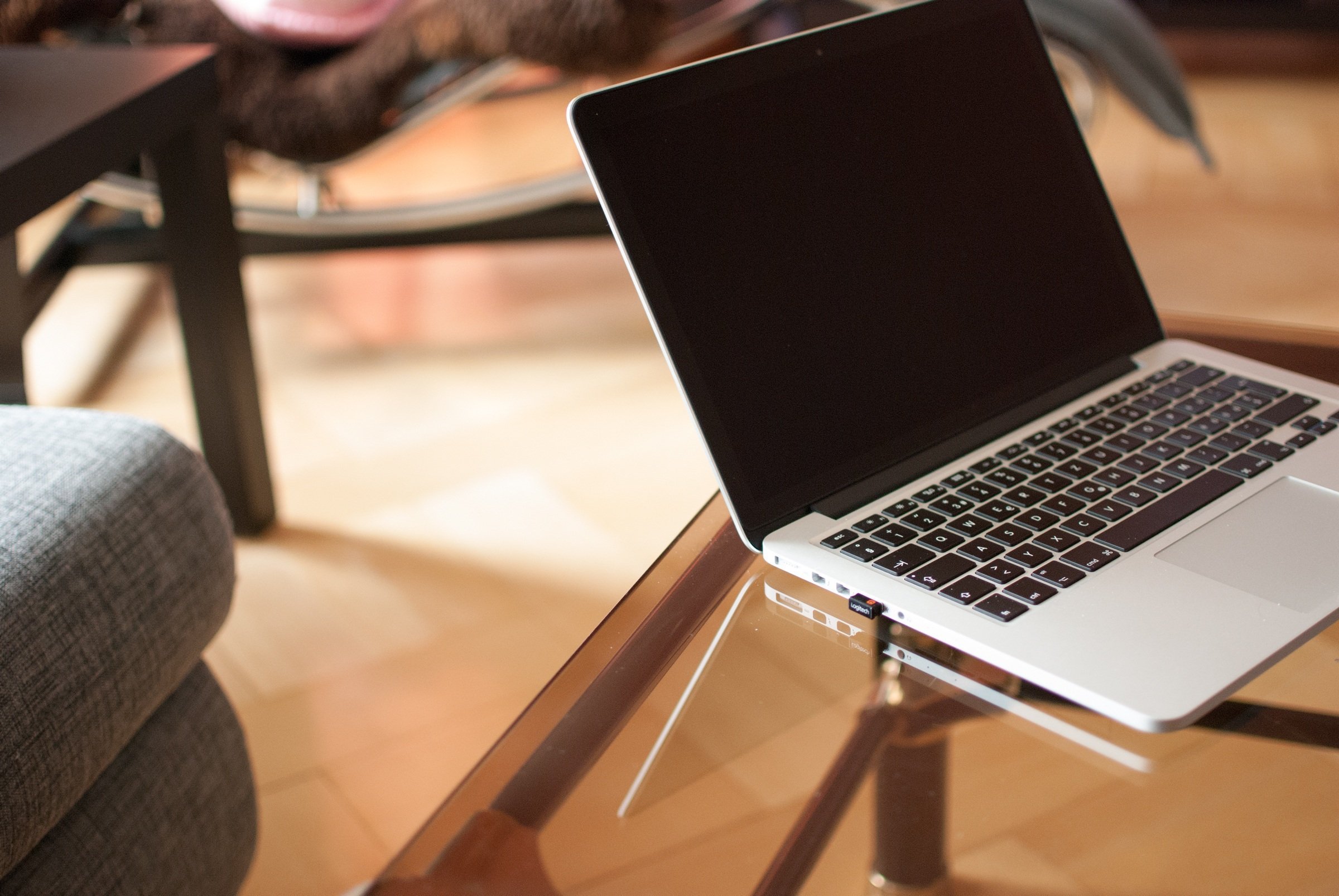 Laptop sitting on a glass table
